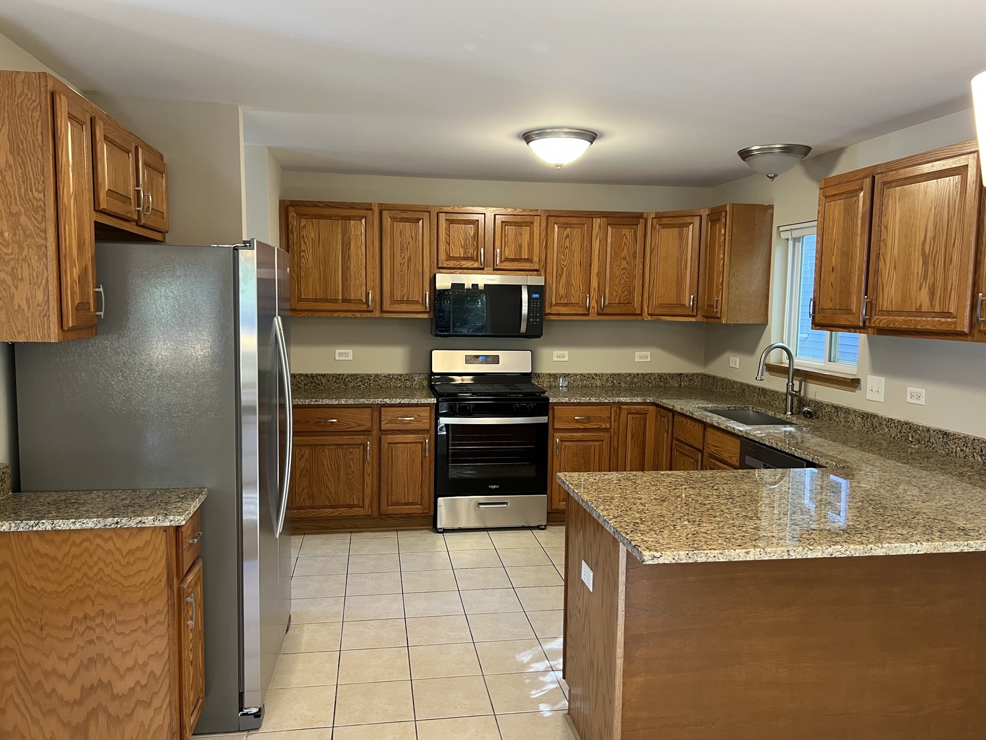 2207 Gabriel Avenue Zion, IL 60099 - Photo 2 of 13 a kitchen with granite countertop a stove top oven and cabinets