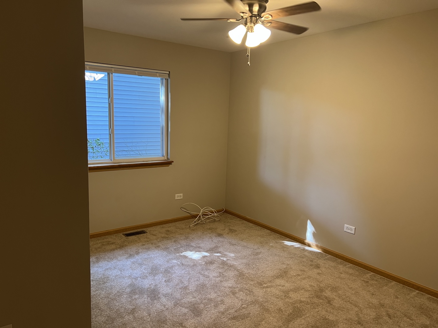 2207 Gabriel Avenue Zion, IL 60099 - Photo 6 of 13 an empty room with windows and fan