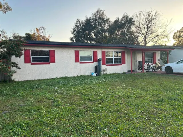 a house that has a tree in front of it
