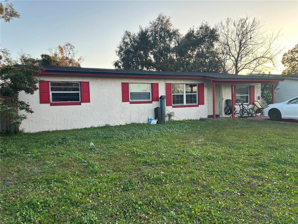 5391 Botany Court Orlando, FL 32811 - Photo 2 of 11 a house that has a tree in front of it