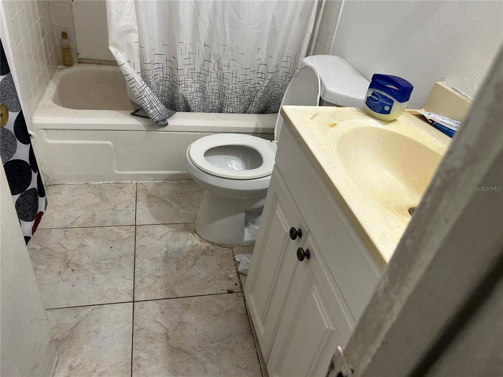 5391 Botany Court Orlando, FL 32811 - Photo 5 of 11 a bathroom with a sink and toilet