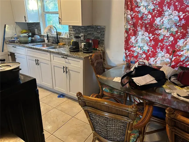 a dining room with furniture and flowers