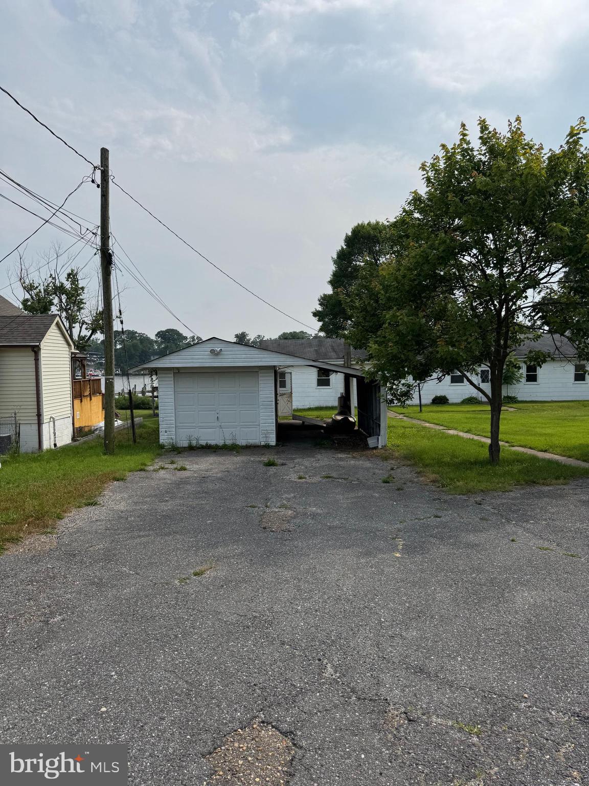 372 Riverside Drive Pasadena, MD 21122 - Photo 18 of 19 a view of a house with a yard and garage