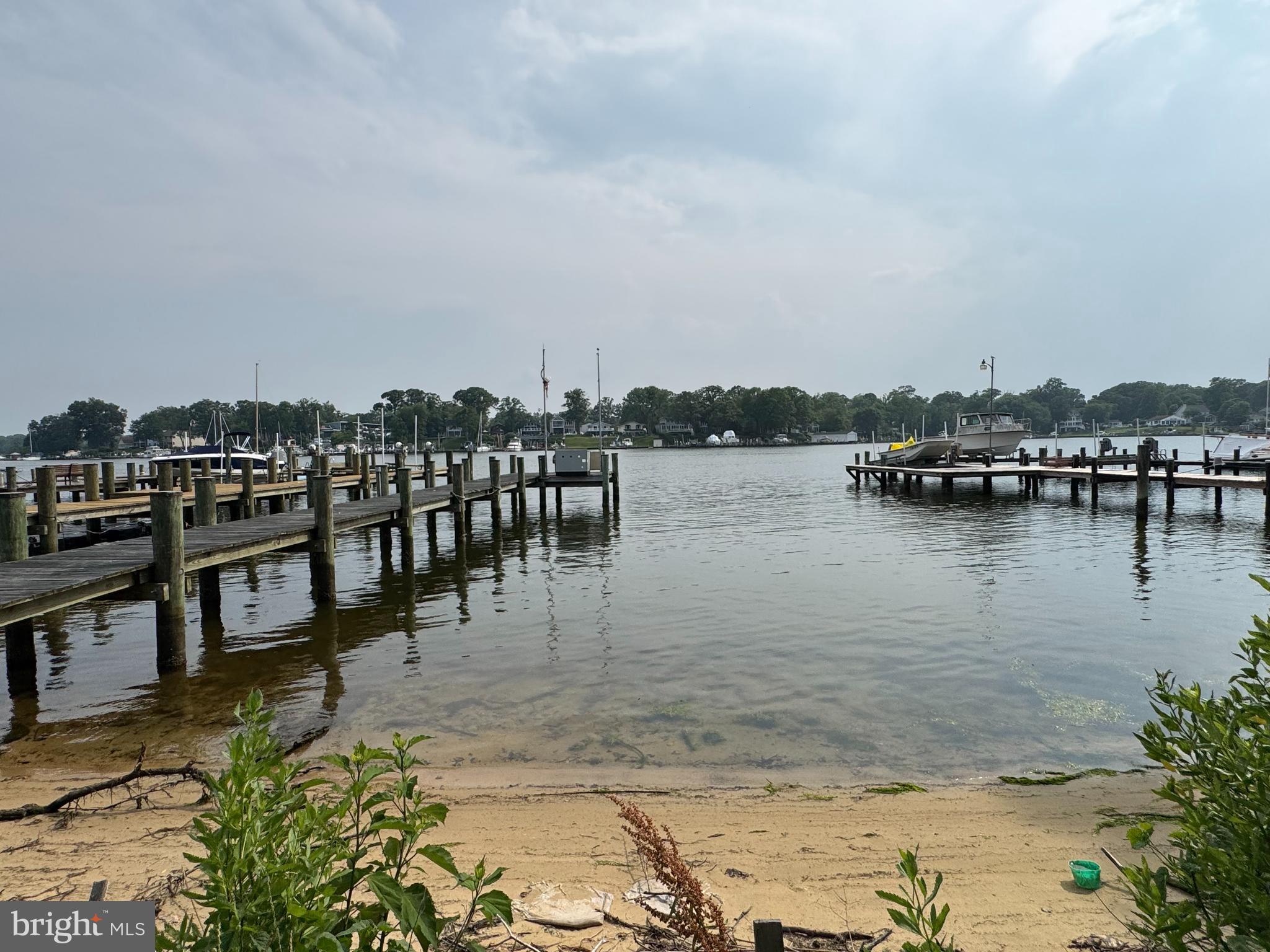 372 Riverside Drive Pasadena, MD 21122 - Photo 7 of 19 a view of a lake with boats and trees in the background