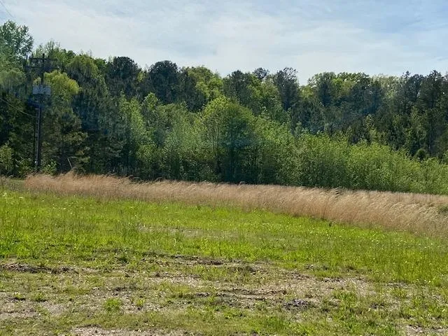 a swimming pool with outdoor seating and yard