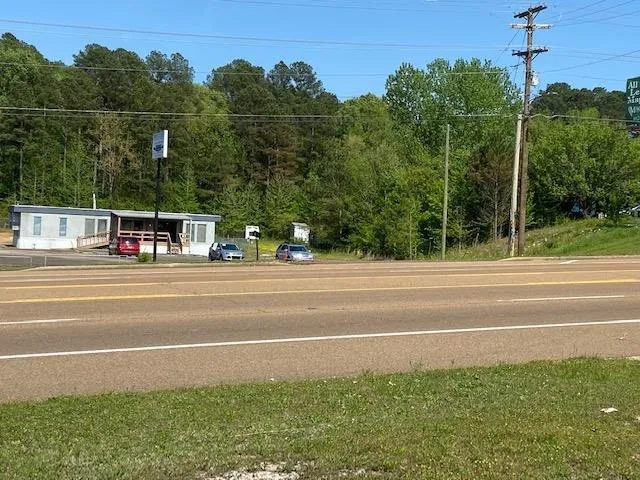 a view of a swimming pool with a yard