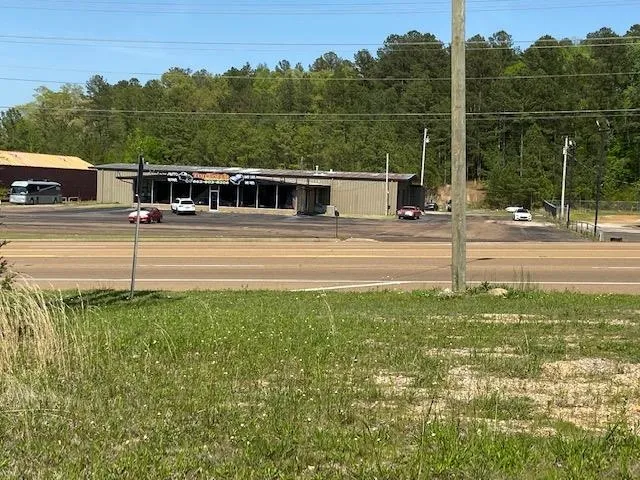 a swimming pool with outdoor seating and yard