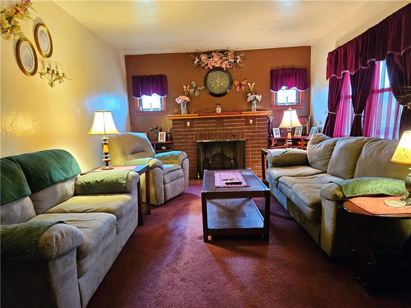 418 Saxonburg Road Butler, PA 16002 - Photo 4 of 27 a living room with furniture a fireplace and a flat screen tv