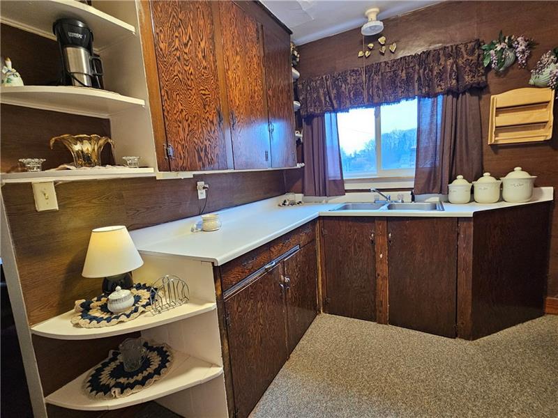 418 Saxonburg Road Butler, PA 16002 - Photo 7 of 27 a kitchen with a sink a stove and wooden floor