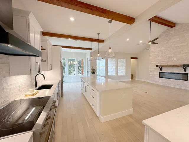 a close view of a stove top oven and cabinets