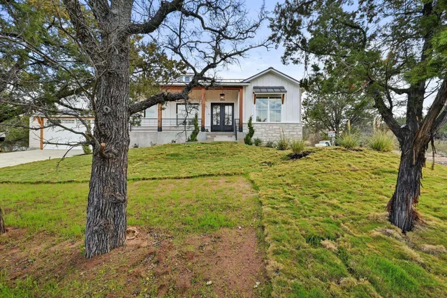 a view of a room with wooden floor and windows