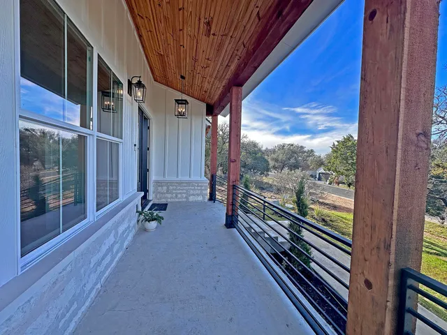 a view of a porch with furniture and a yard