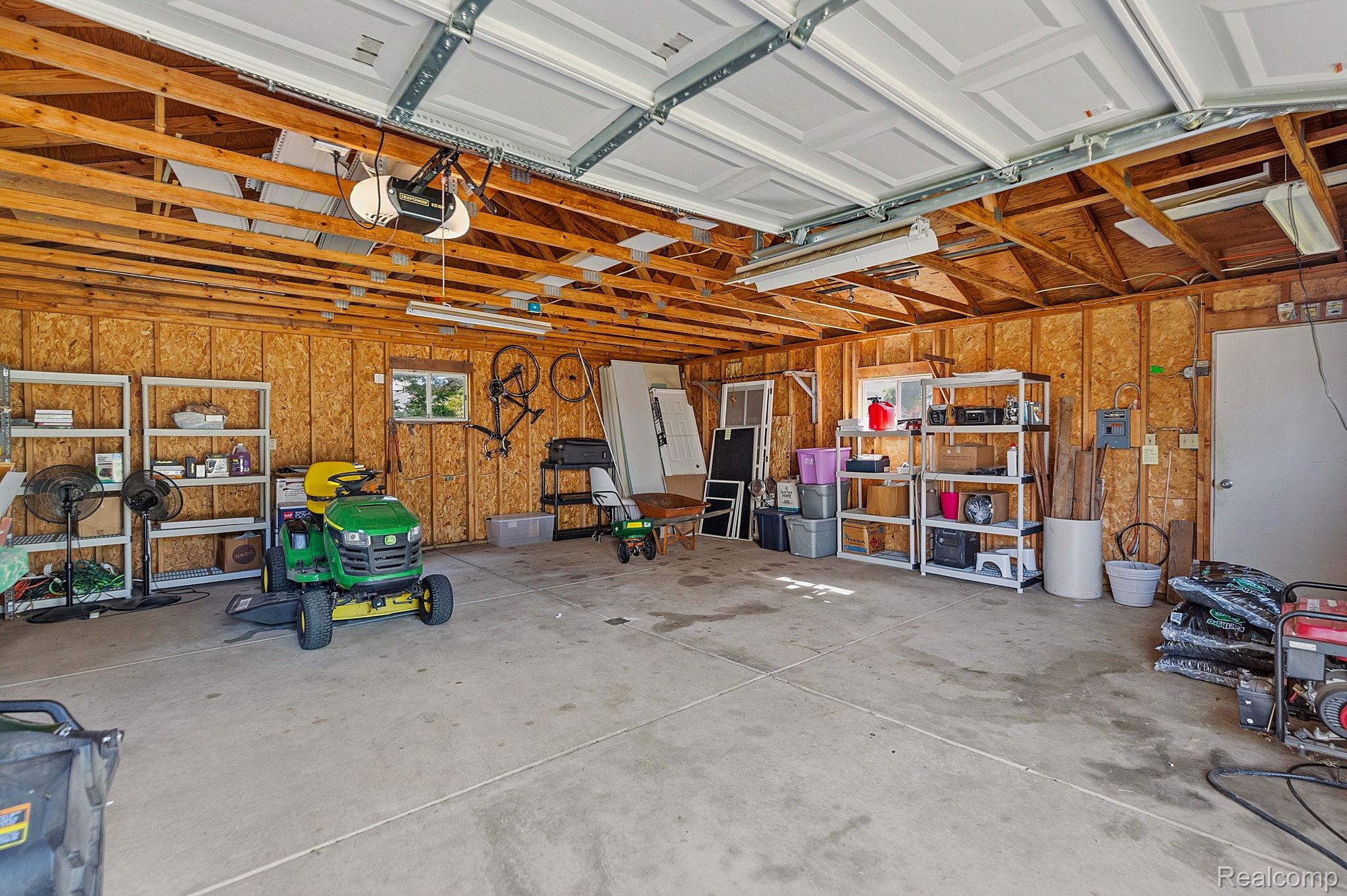 8710 32 Mile Road Washington, MI 48095 - Photo 46 of 60 Spacious garage with concrete flooring, exposed wood beam ceiling, and overhead lighting