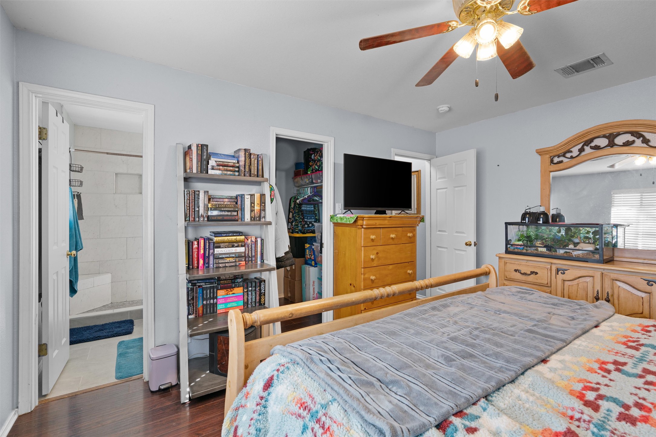 128 Steven Street Hutto, TX 78634 - Photo 12 of 29 a bedroom with furniture and a flat screen tv