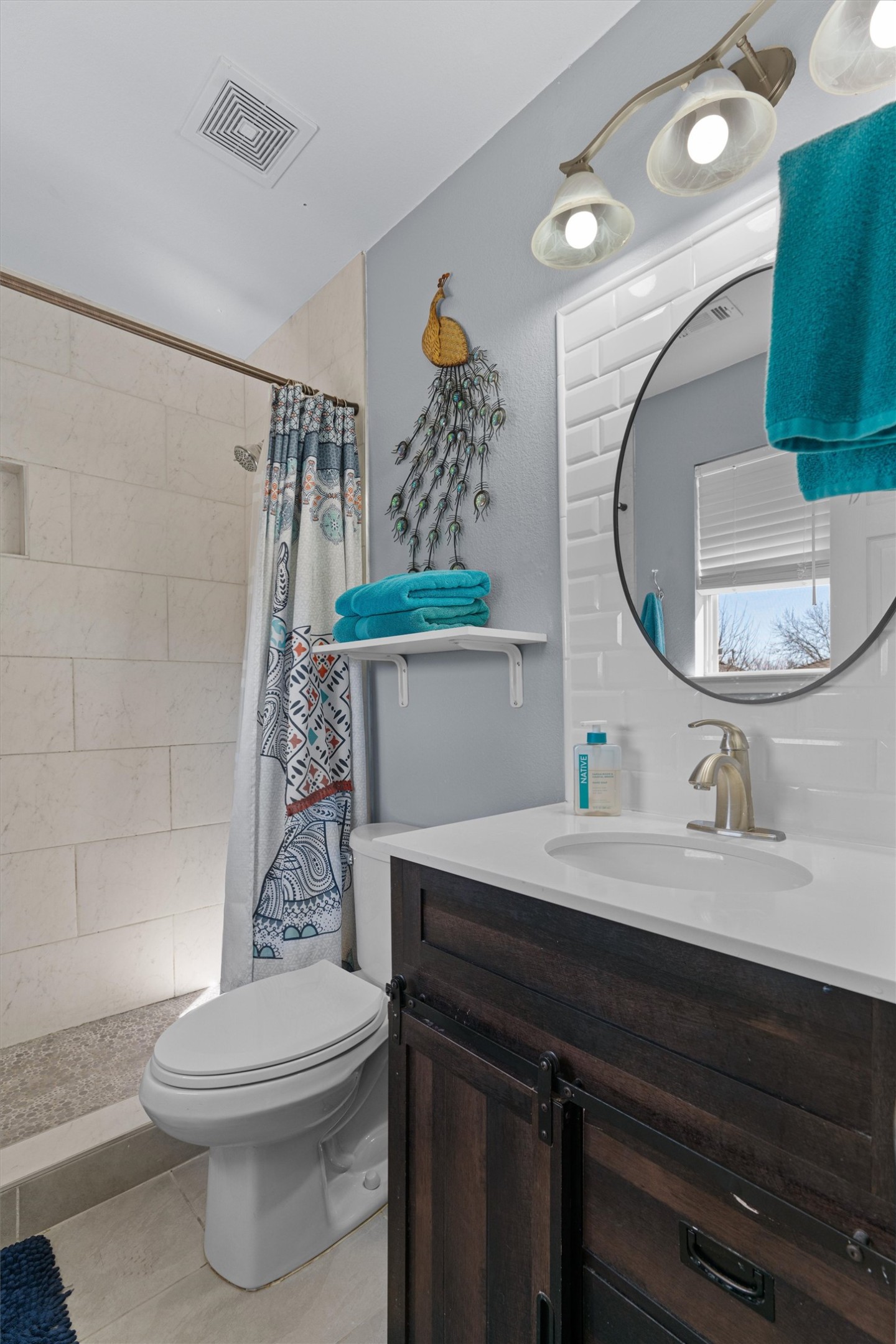 128 Steven Street Hutto, TX 78634 - Photo 15 of 29 a bathroom with a sink a toilet and shower