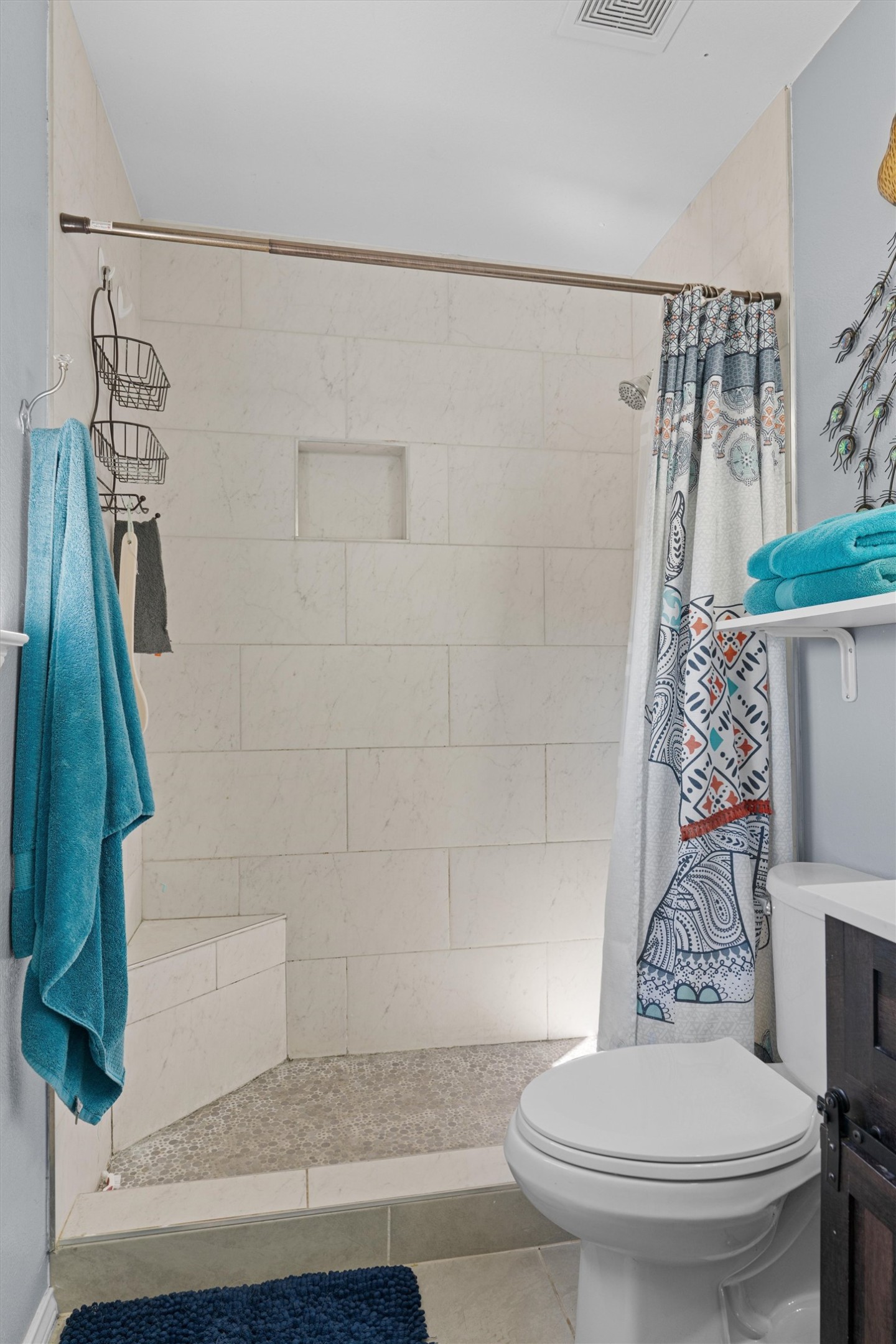 128 Steven Street Hutto, TX 78634 - Photo 16 of 29 a bathroom with a toilet and a shower