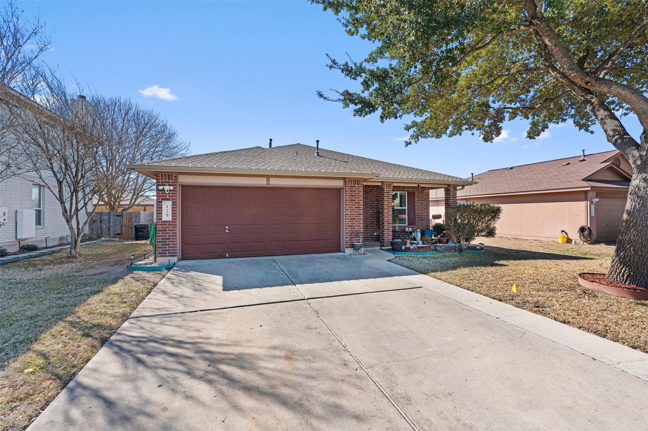 128 Steven Street Hutto, TX 78634 - Photo 2 of 29 a front view of a house with a yard and garage