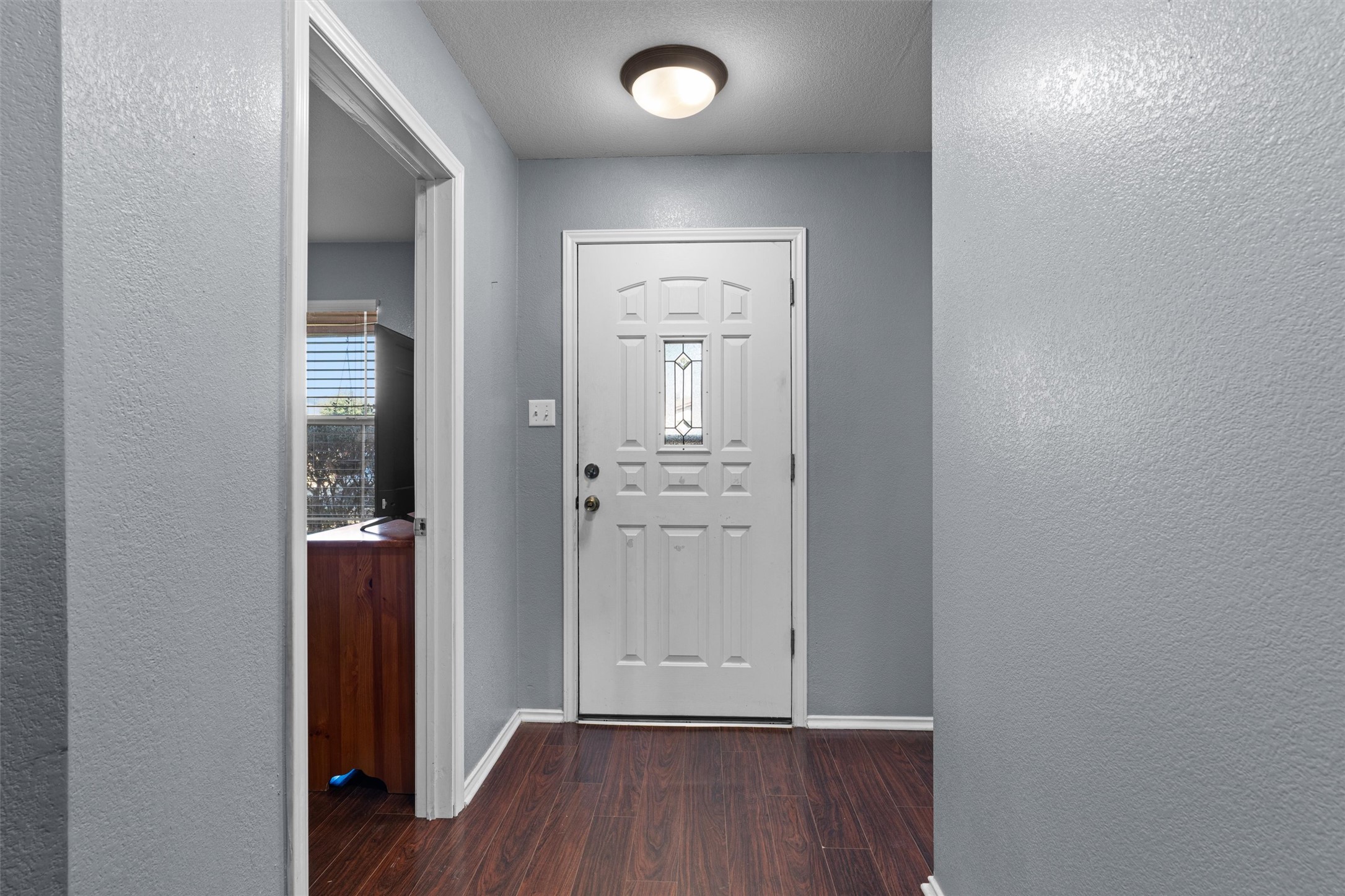 128 Steven Street Hutto, TX 78634 - Photo 3 of 29 an empty room with wooden floor and a window