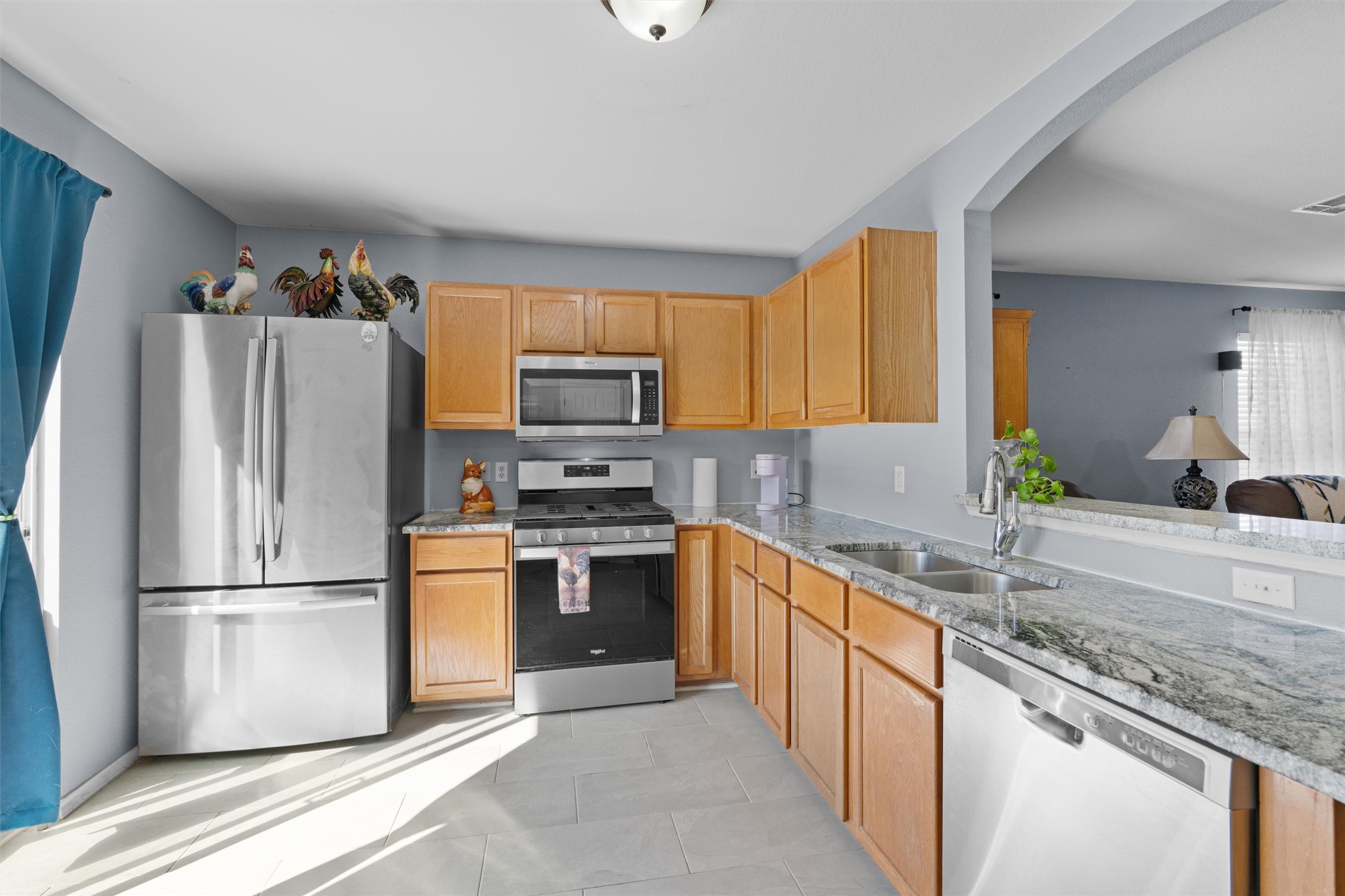 128 Steven Street Hutto, TX 78634 - Photo 8 of 29 a kitchen with stainless steel appliances granite countertop a refrigerator stove microwave and sink