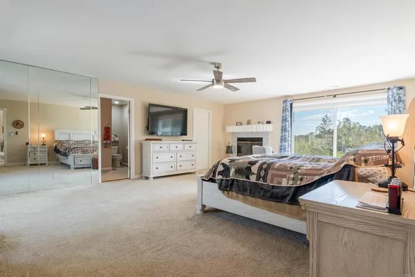 a spacious bedroom with a bed and a large window