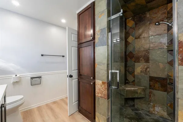 a bathroom with a shower and toilet