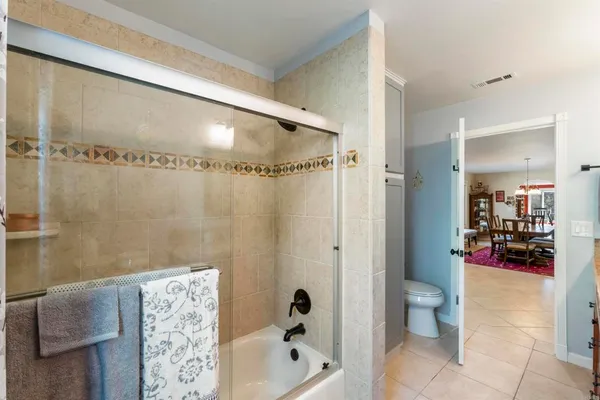 a bathroom with a bathtub shower sink and toilet