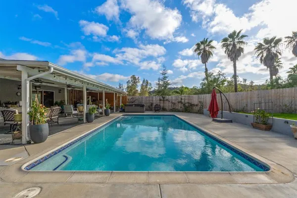 a view of swimming pool with outdoor seating