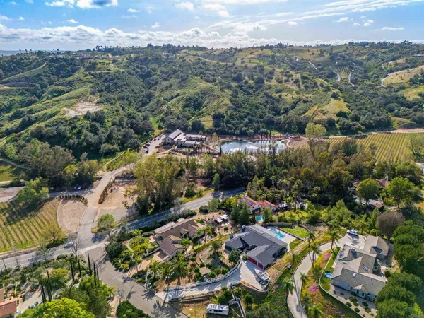 an aerial view of residential houses with outdoor space and swimming pool