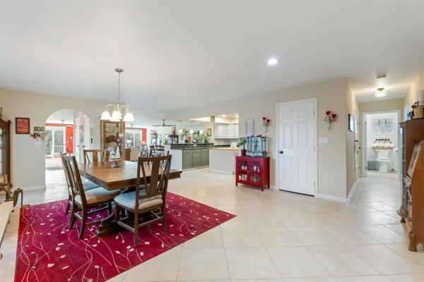 a dining room with furniture and a chandelier