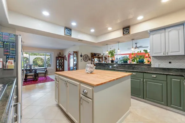 a kitchen with stainless steel appliances granite countertop a sink and cabinets