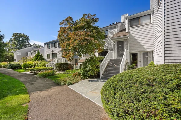 a front view of a house with a garden