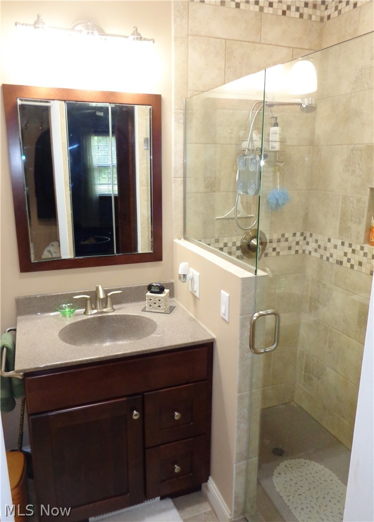 4323 Sunnybrook Road Kent, OH 44240 - Photo 21 of 32 Small but mighty. the master bath offers a tile walk-in shower, updated vanity with solid-surface integrated sink.
