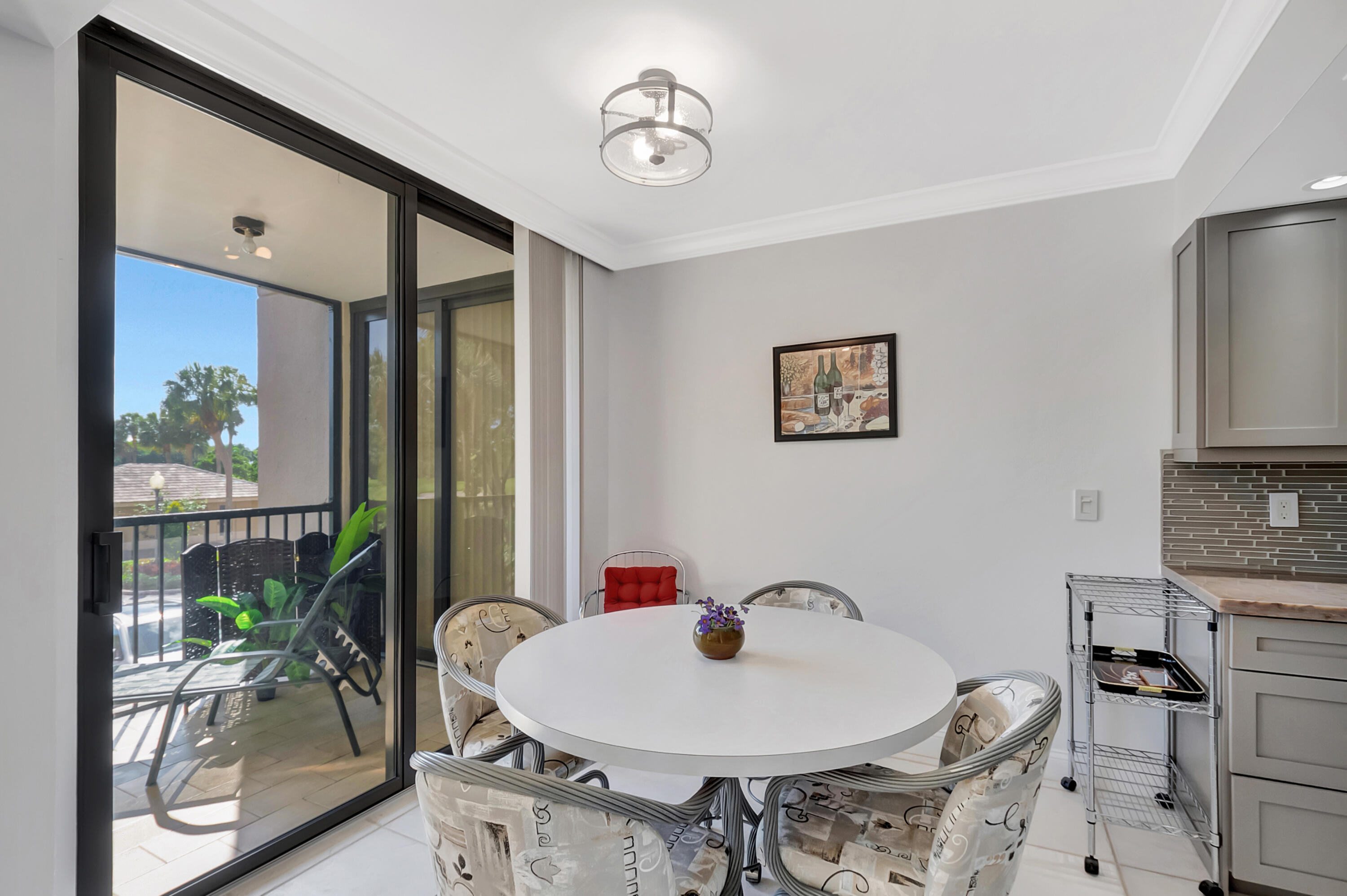 20100 Boca W Drive, Unit 126 Boca Raton, FL 33434 - Photo 13 of 58 a dining room with furniture and window