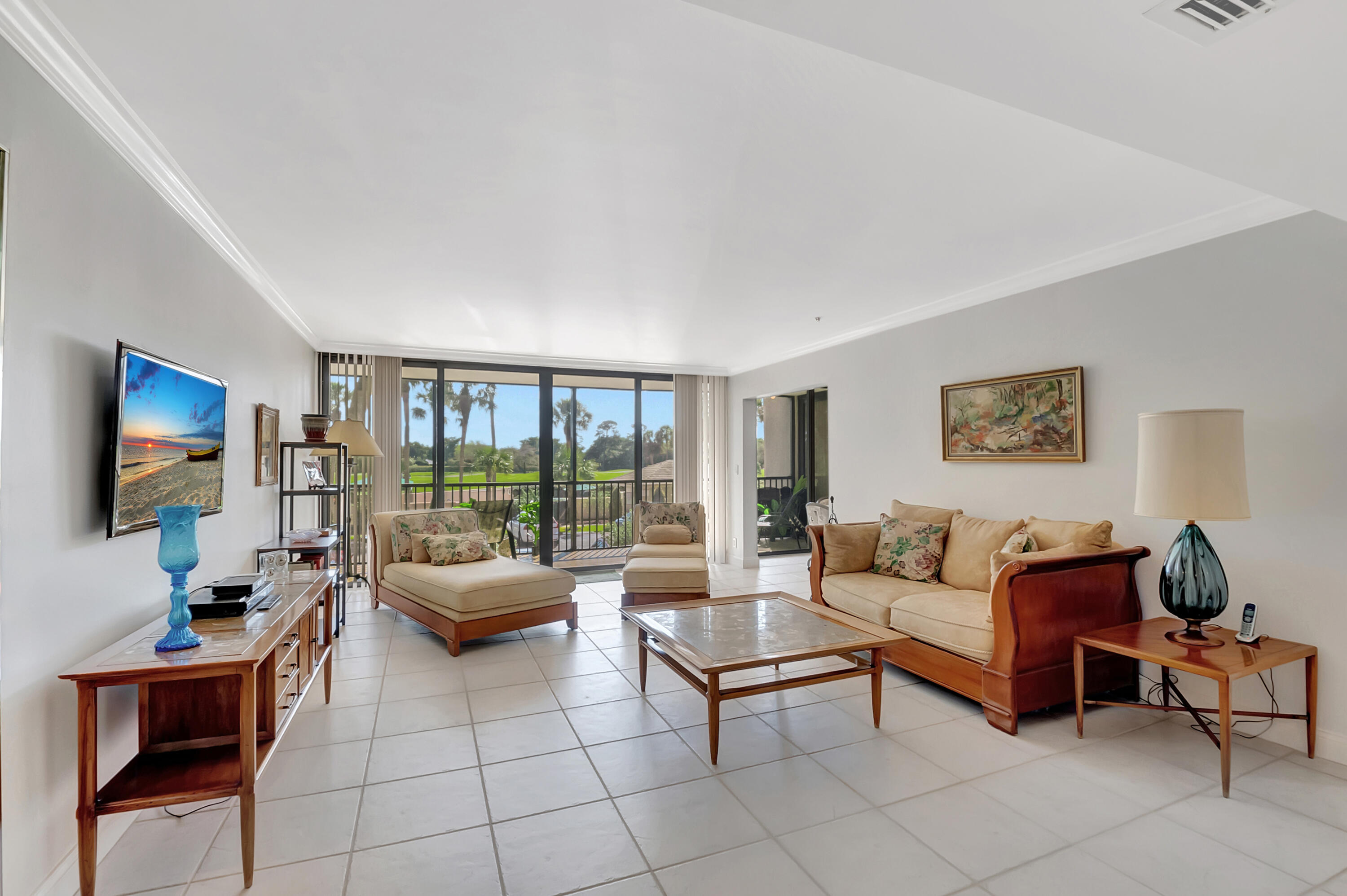 20100 Boca W Drive, Unit 126 Boca Raton, FL 33434 - Photo 15 of 58 a living room with furniture and a flat screen tv
