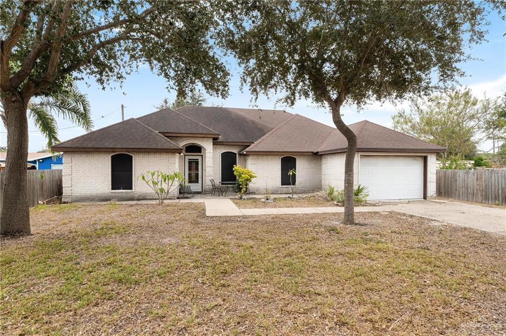 2101 Happy Street Mission, TX 78573 - Photo 1 of 20 a front view of a house with a yard and garage