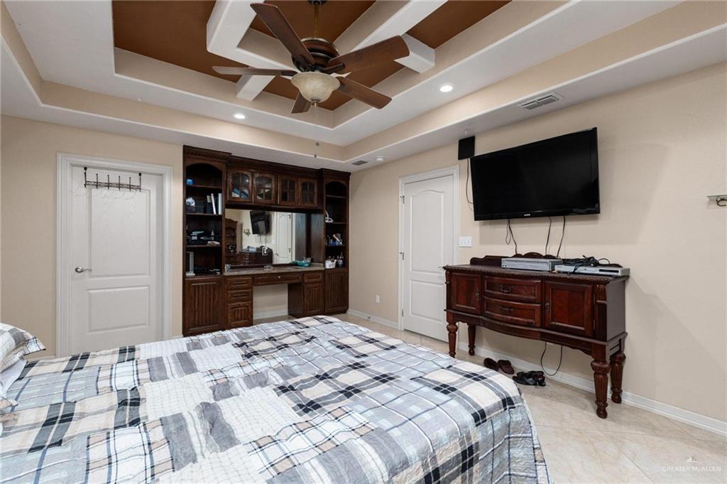 2101 Happy Street Mission, TX 78573 - Photo 11 of 20 a bedroom with a bed and a flat screen tv