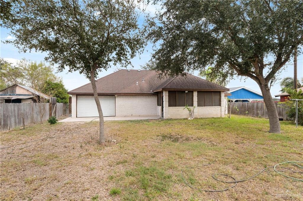 2101 Happy Street Mission, TX 78573 - Photo 14 of 20 a front view of a house with a yard and garage