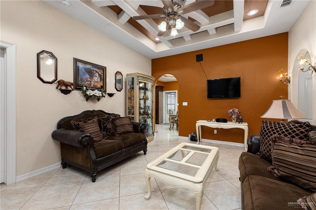 2101 Happy Street Mission, TX 78573 - Photo 2 of 20 a living room with furniture a chandelier and a flat screen tv