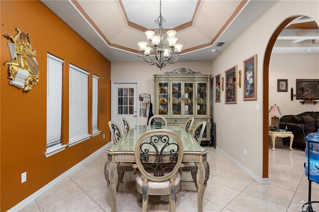 2101 Happy Street Mission, TX 78573 - Photo 3 of 20 a view of a dining room with furniture and chandelier