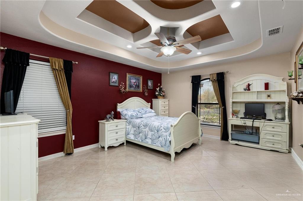 2101 Happy Street Mission, TX 78573 - Photo 8 of 20 a bedroom with furniture and a flat screen tv