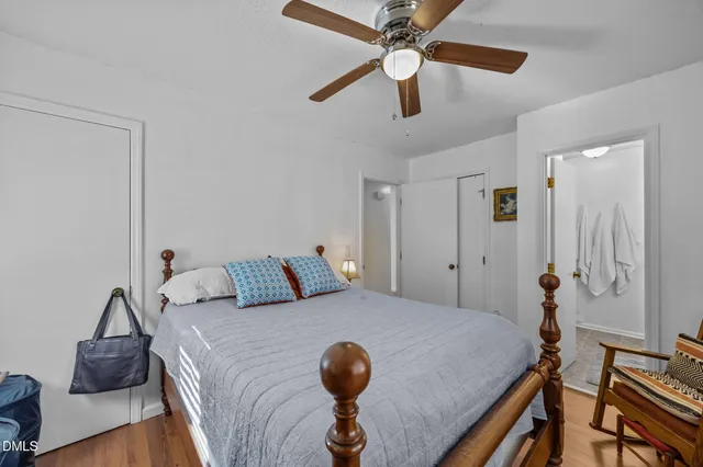 a bedroom with a bed a window and a flat screen tv