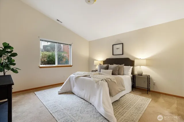 a bedroom with a large bed and a window