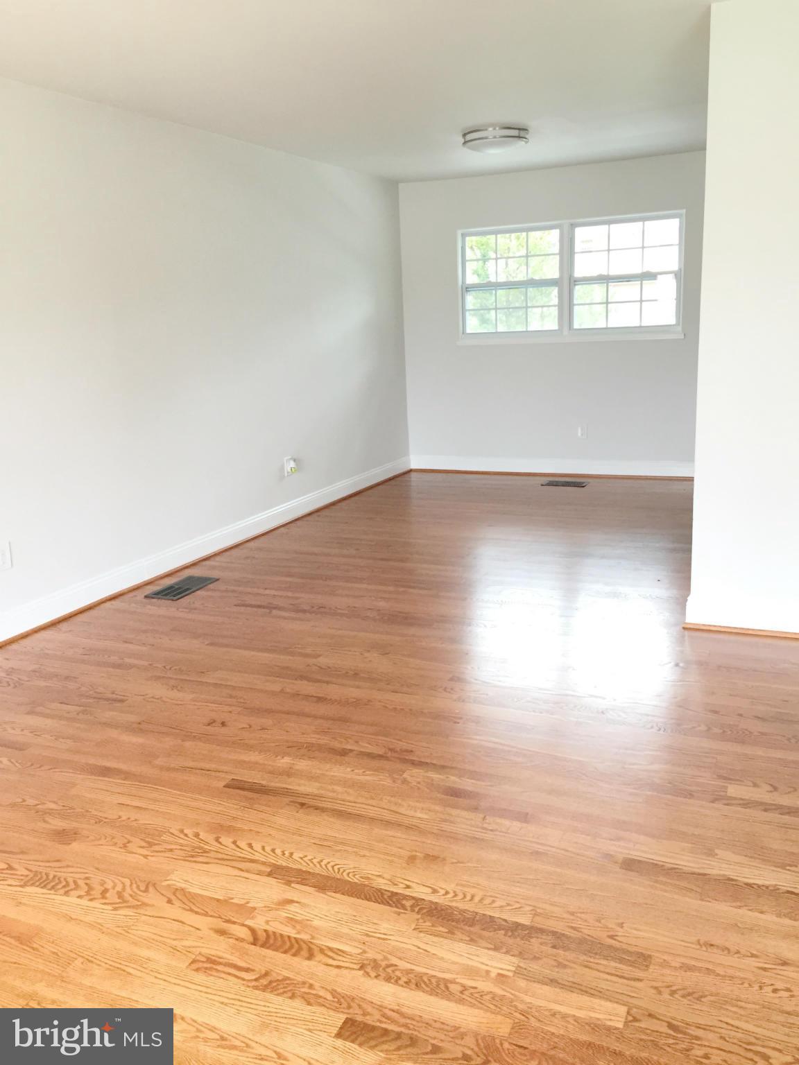 5705 Westgate Road Lanham, MD 20706 - Photo 17 of 26 a view of wooden floor and windows in a room