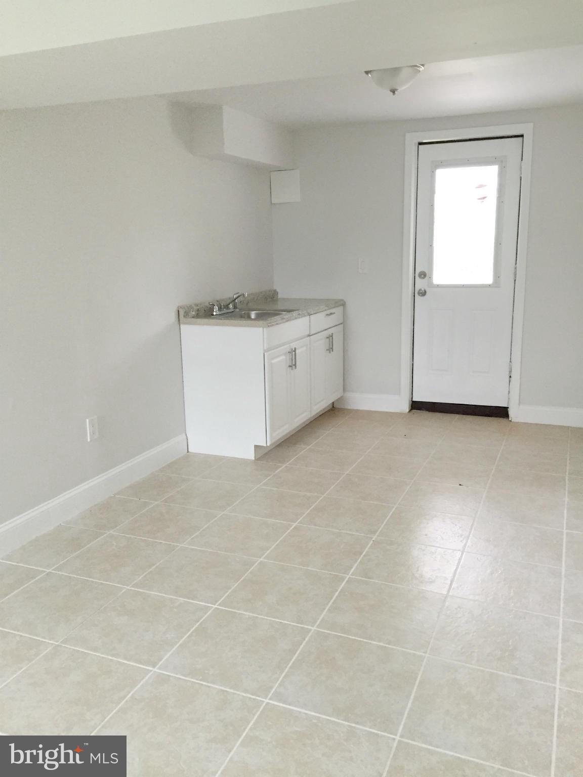 5705 Westgate Road Lanham, MD 20706 - Photo 22 of 26 a utility room with cabinets washer and dryer