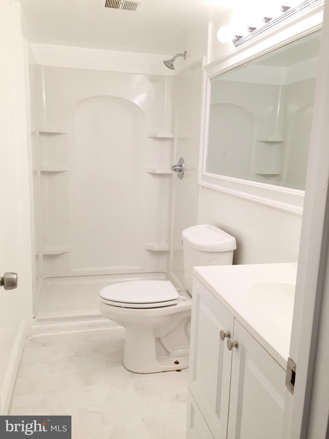 5705 Westgate Road Lanham, MD 20706 - Photo 7 of 26 a bathroom with a toilet and a shower