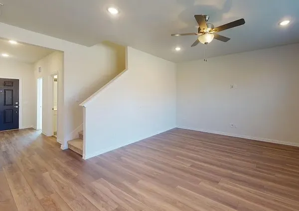 a view of an empty room with wooden floor