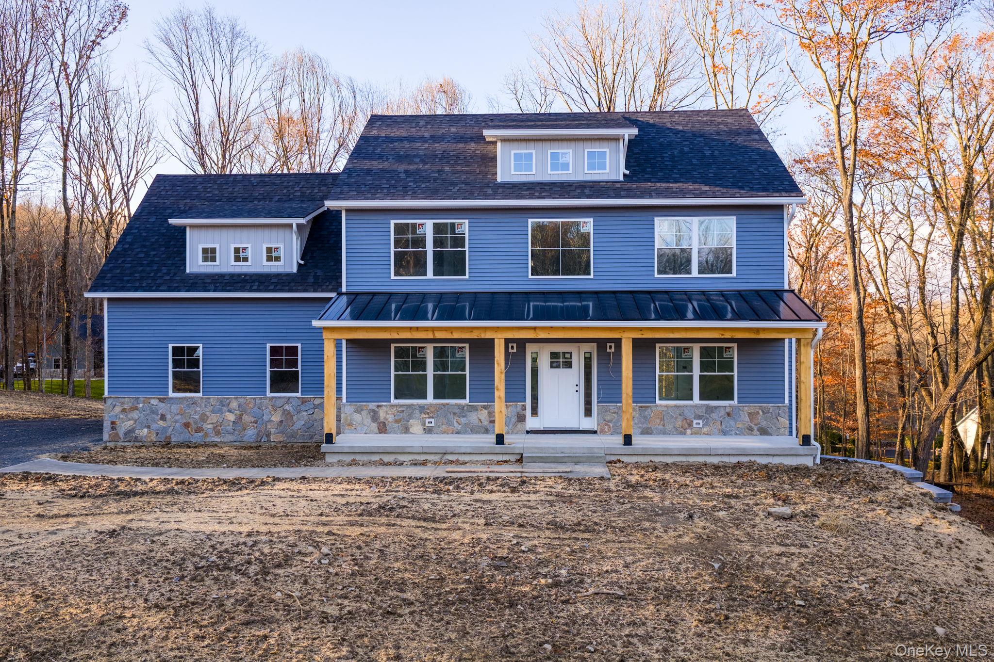 48 West Corbett Road Montgomery, NY 12549 - Photo 2 of 38 View of front of home featuring covered porch, stone siding, a shingled roof, and a standing seam roof
