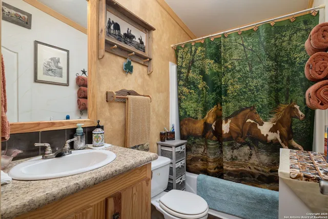a bedroom with furniture and a flat screen tv