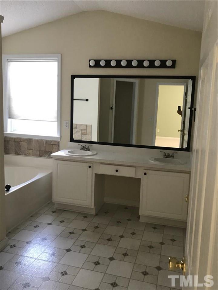 4528 Drewbridge Way Raleigh, NC 27604 - Photo 11 of 25 a bathroom with a sink vanity and mirror