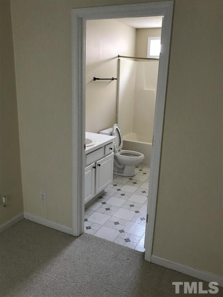4528 Drewbridge Way Raleigh, NC 27604 - Photo 17 of 25 a bathroom with a granite countertop sink toilet and shower